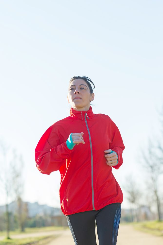 Woman running outdoors on sunny day