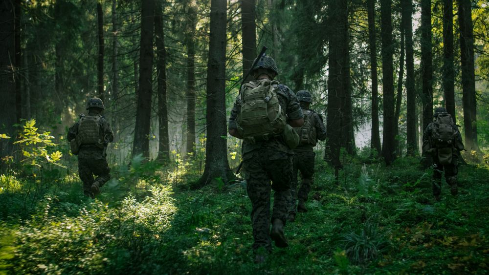 Fully Equipped Soldiers Wearing Camouflage Uniform Attacking Enemy, Rifles Ready to Shoot.