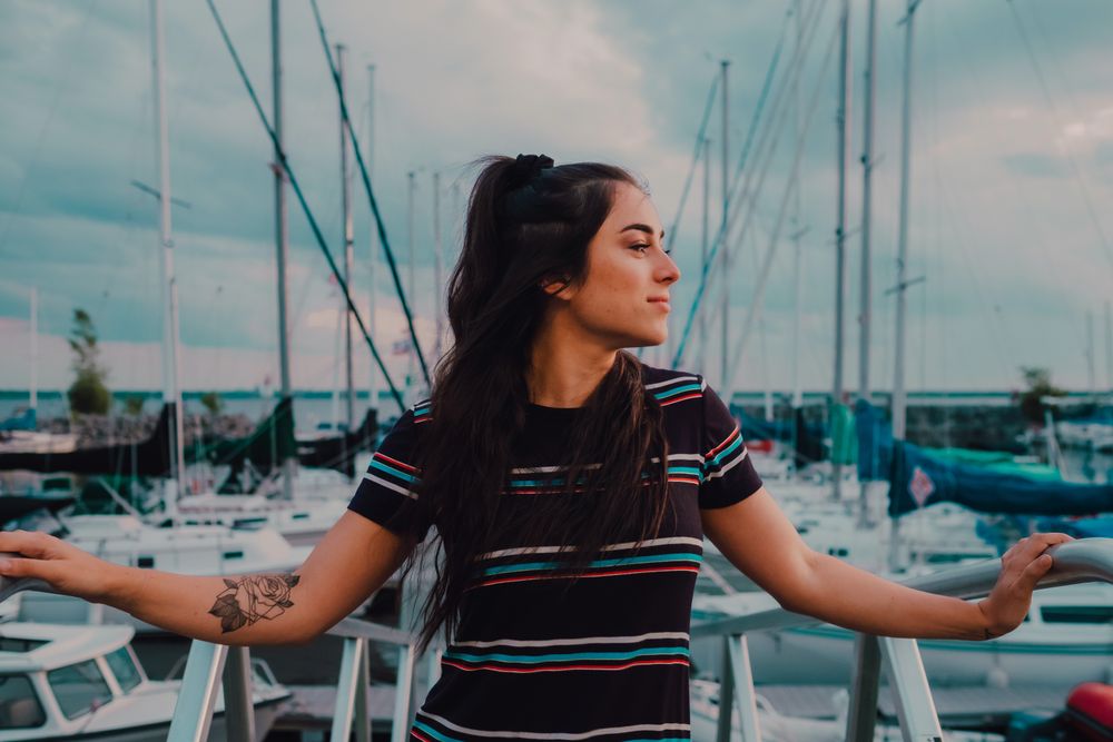 Smiling female walking standing on busy urban pier