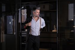 Mature man in elegant suit putting on jacket