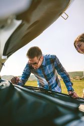 Young couple tries to fix the broken down car