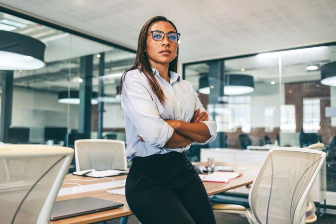 Confident businesswoman looking thoughtful in a modern office