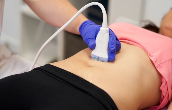 a physiotherapist performing an ultrasound scan for pelvic floor