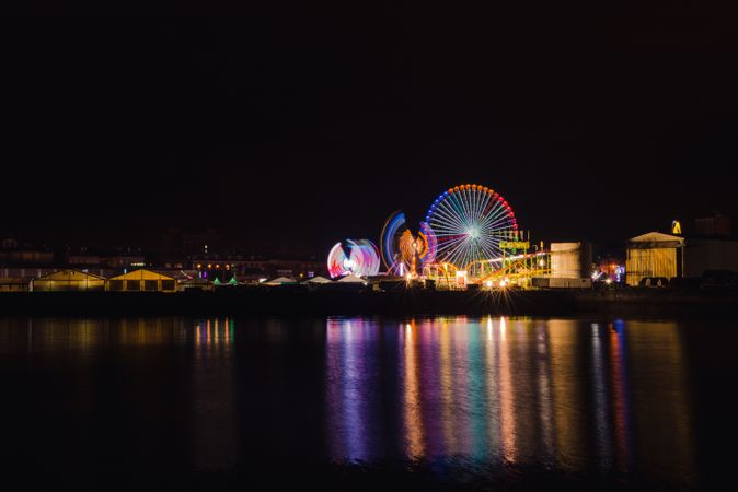 Ferris wheel on city embankment in night time