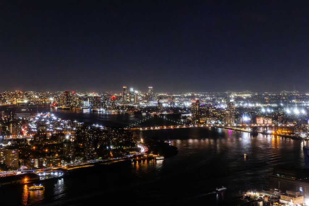 Helicopter Tour of New York City Architecture at Night. Midtown Manhattan Office Buildings and Skyscrapers. Aerial Urban Landscape with Lights in the Evening