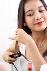 Asian Indonesian Woman Straightening Hair