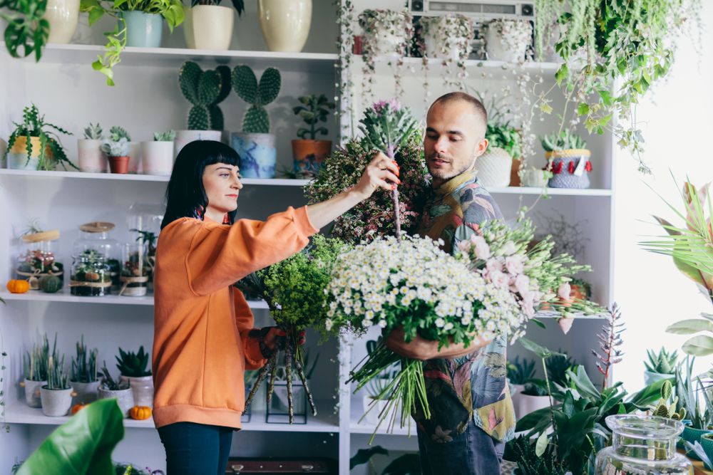 Man and woman making bouquets in the flower shop.
