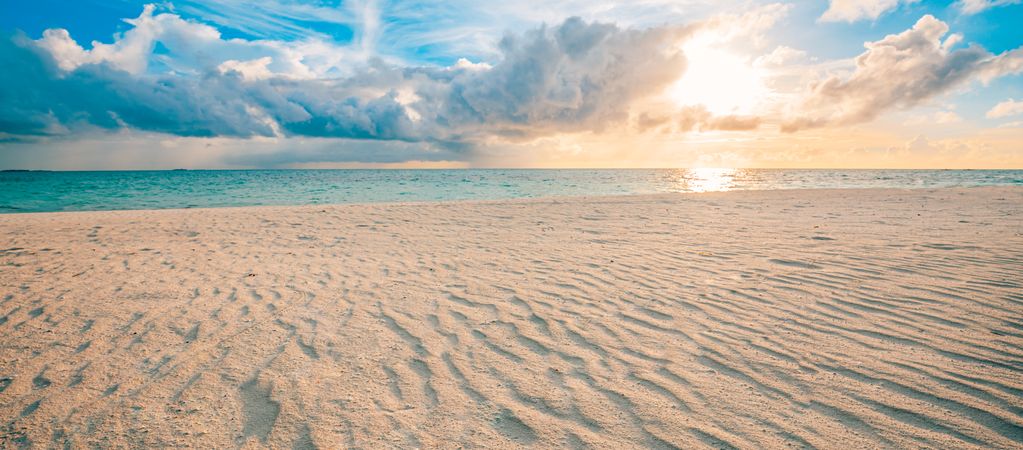 Wide shot of beautiful beach at sunset