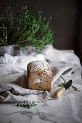Fresh bread on napkin near tomatoes jam