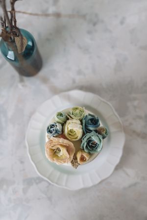 Buttercream flowers cake, blue and pastel peach colors