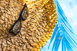 Summer hat with palm leaf and sunglasses