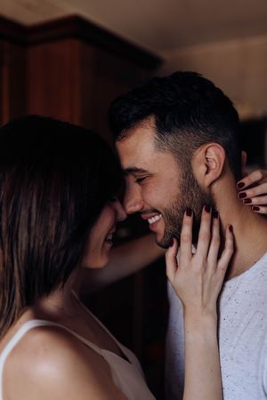Happy couple embracing in kitchen