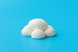 Mozzarella balls isolated on a blue background