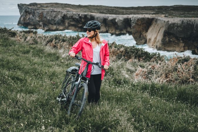 Female bicyclist on rocks