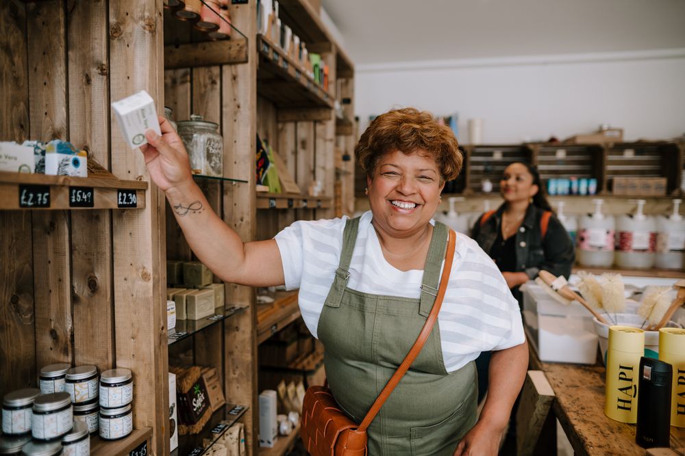 Smiling mature Black woman in soap shop