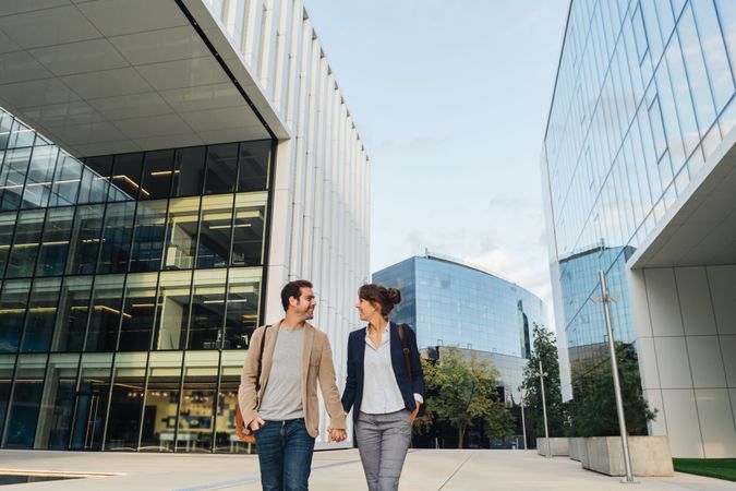 Businesspeople couple outside contemporary building