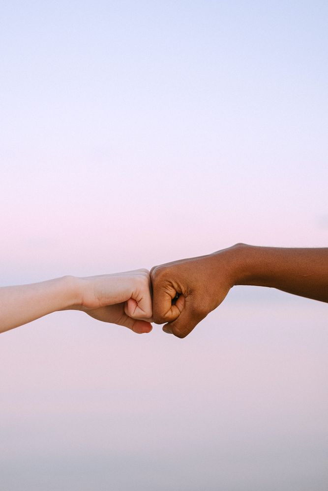 Cropped image of two hands fist bump