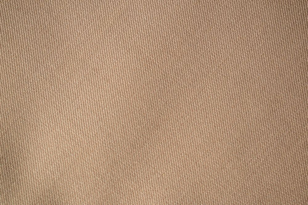 Detailed flat view Light brown pattern fabric texture background.