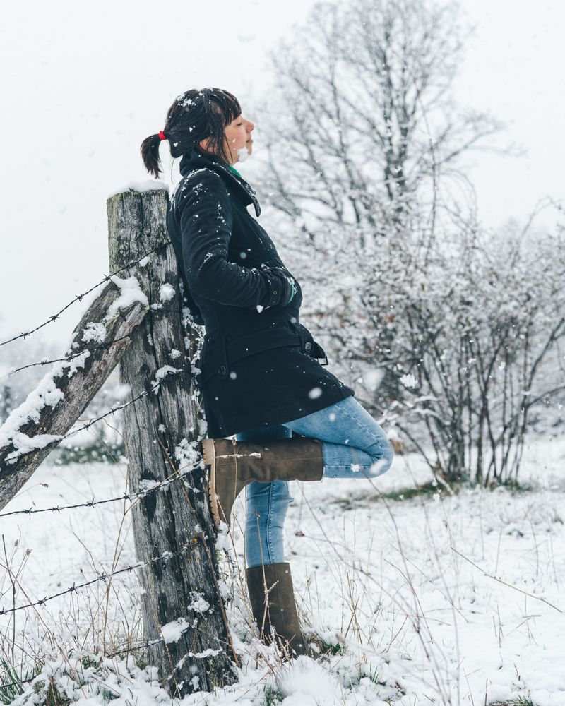 Young woman enjoying snow day on countryside