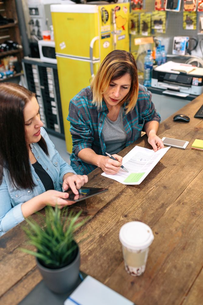 Women entrepreneur reviewing the balance with expense and cost of small business.