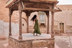 Woman dancing on street stage between ancient buildings