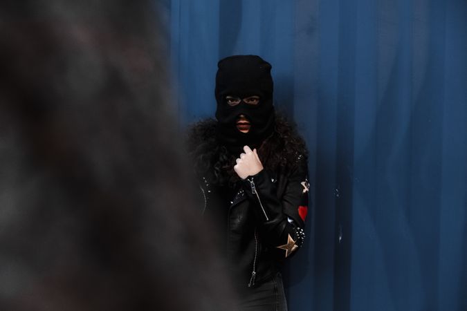 Woman in balaclava and leather jacket