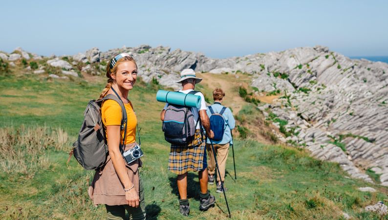 Smiling woman on a hike with her older parents