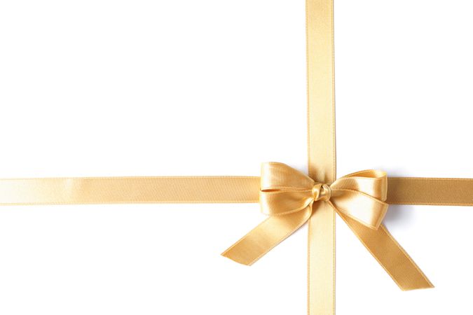 Golden ribbon with bow isolated on plain background. Gift concept