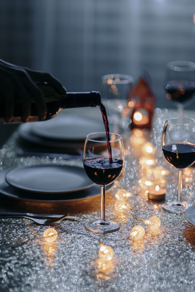 Wine being poured into a glass at holiday dinner