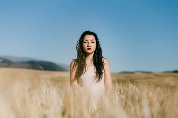 Woman standing in field looking at camera