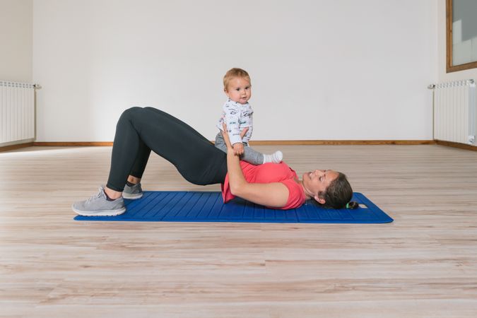 Mother exercising with baby in gym