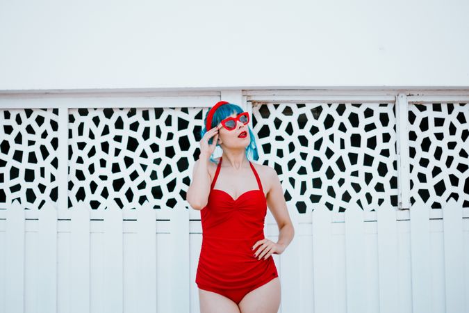 Stylish woman in red swimwear with hand on waist