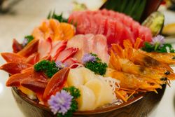 Japanese food raw fish mixed sashimi in brown wooden bowl