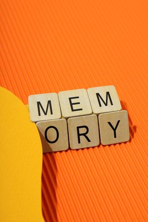 Orange duotone with the word “memory” in wooden blocks, vertical