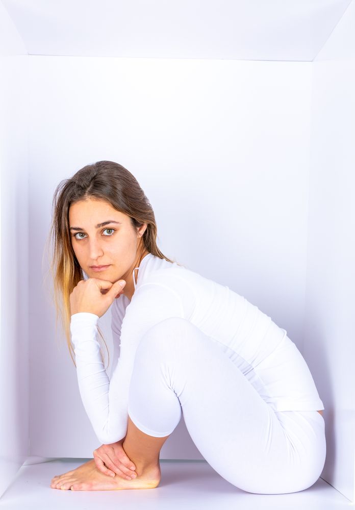 Woman wearing white posing in box