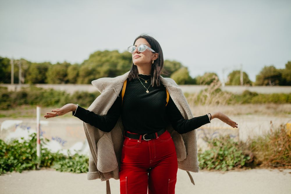 Stylish woman with jacket on beach
