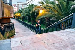 Female training running up stairs surrounded by palms