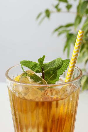 A glass of cold tea with fresh orange slices