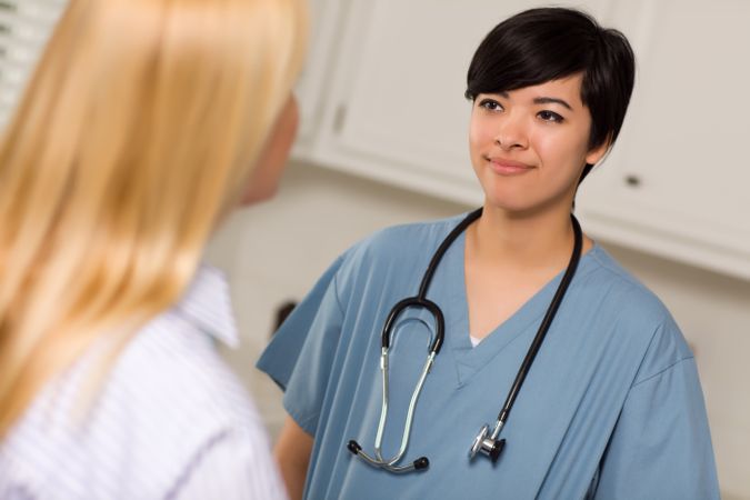 Young Female Doctor Talking with Patient