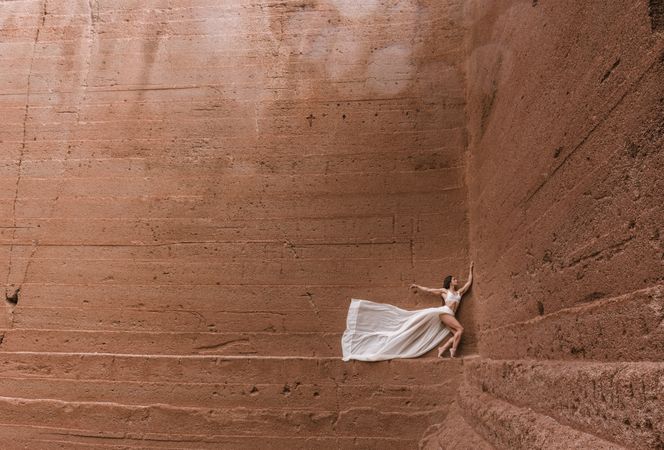 Elegant female posing on rocky cliff