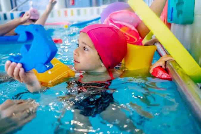 girl with water wings in swimming pool
