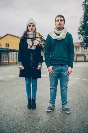 Man and woman standing next to each other in circle in sports court