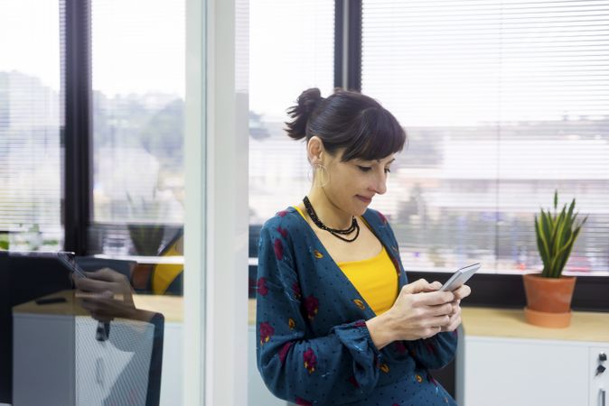 Businesswoman using smartphone at office