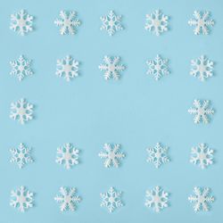 Snowflakes arranged on blue background