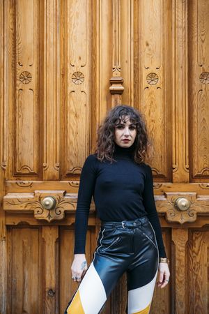 Trendy woman near ornamental door