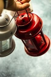 Hand holding decorative Christmas lanterns