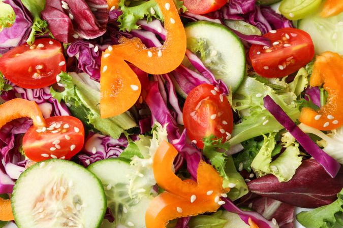 Fresh salad with sesame on whole background, close up