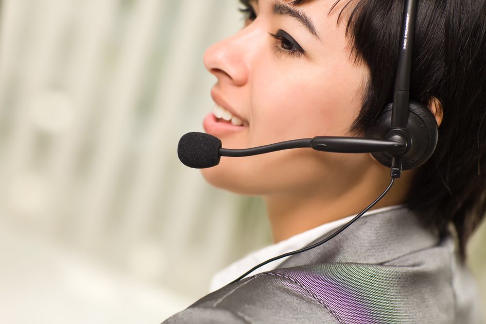 Profile of Young Woman Smiles Wearing Headset