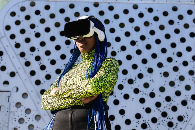 Black woman in VR headset in city