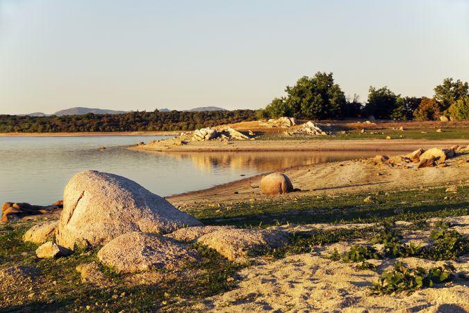 Picturesque view of lake with countryside route, fir forest and hills in Valmayor lake Spain